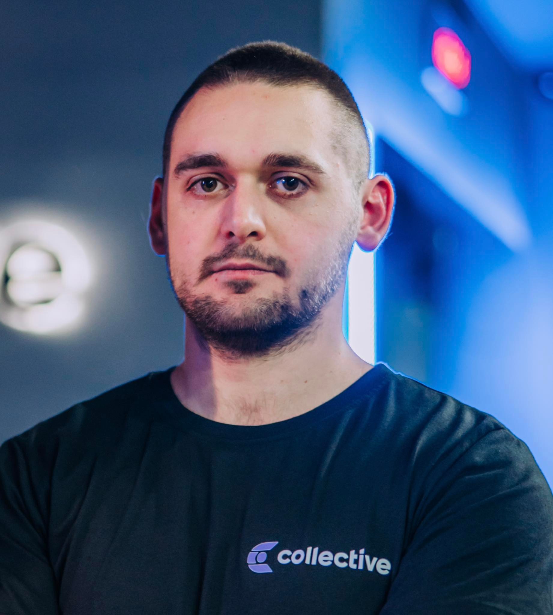 Fit male trainer standing in a gym with equipment in background